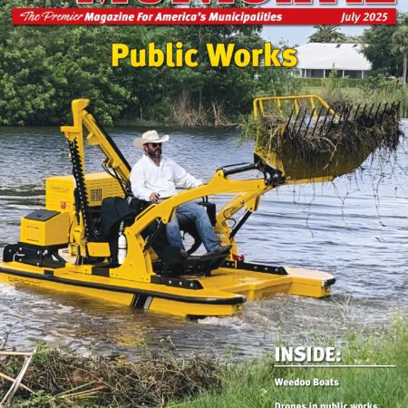 Yellow aquatic weed harvester removing shoreline vegetation